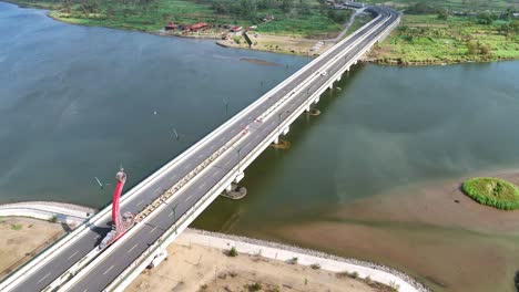 aerial view of vehicles driving on paved roads on bridges that cross large rivers. kretek ii bridge, yogyakarta, indonesia