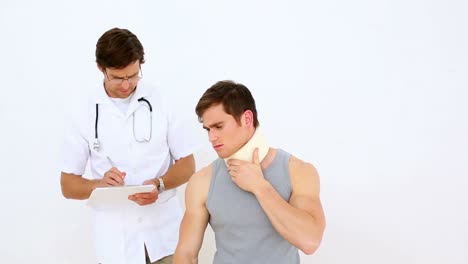 physiotherapist speaking to patient wearing a neck brace