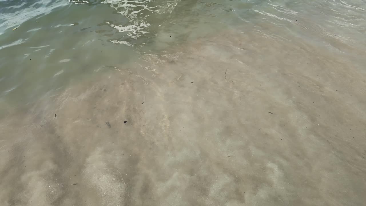 Cloudy ocean water small waves mixed with sand particles Gulf of Thailand