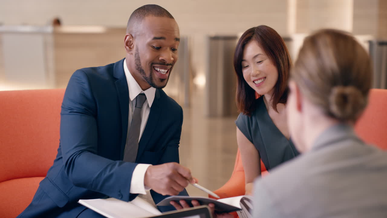 Multi-Ethnic Business people working in business lobby