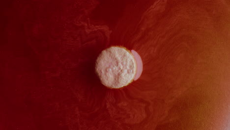floating pill in colored liquid