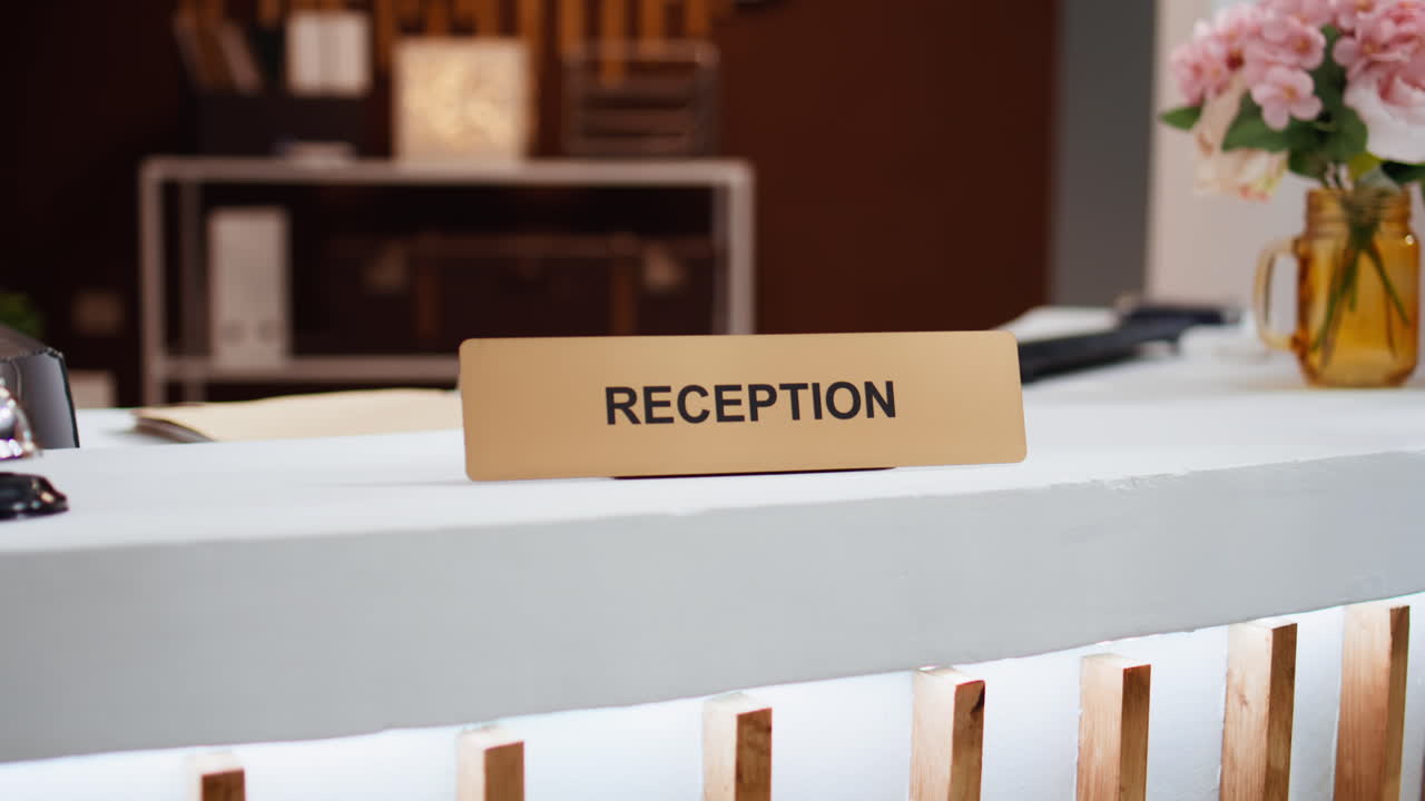 Reception sign placed on front desk in hotel lobby