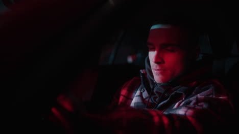 young man driving at night