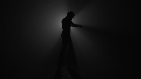 silhouette of fighter punching in dark