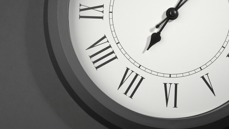 Latin Clock Face in Time Lapse on Dark Grey Wall