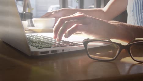 Animation-of-light-spots-over-caucasian-businesswoman-in-office