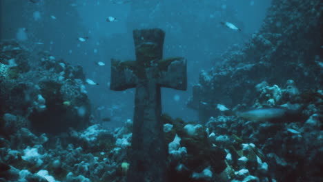 underwater exploration reveals a sunken cross amid vibrant marine life