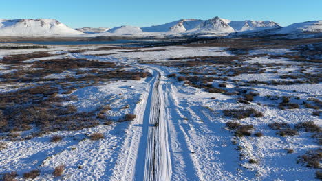 Car driving through snowy road in Caviahue Argentina surrounded by extreme winter landscape