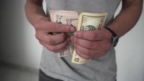 man counting dollars to pay