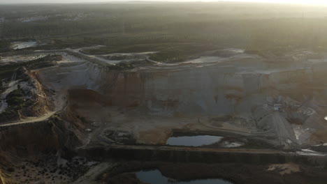 giant hole in the ground as a landfill, in the middle of the woods