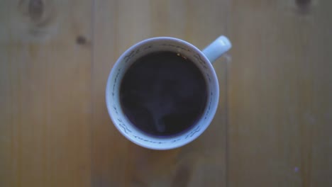hot black coffee in a white cup on a table. tasty coffee. caffeine.