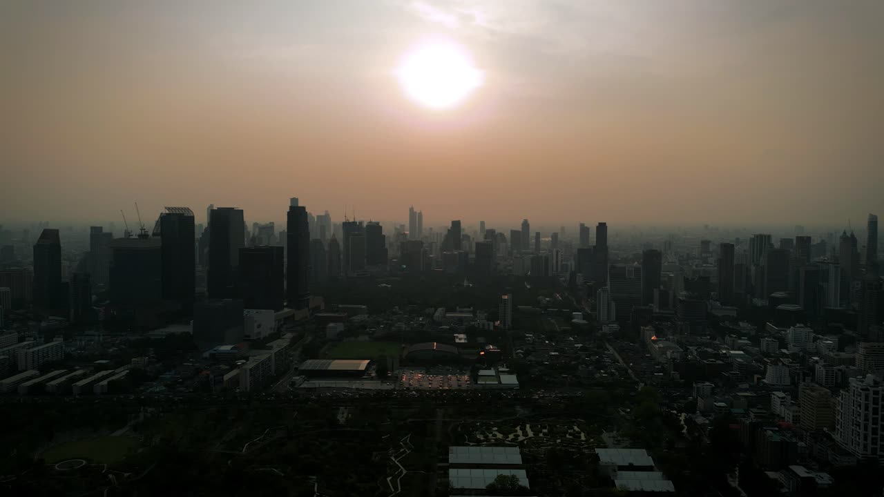 Aerial Scenic Drone Footage of the Skyline of Downtown Bangkok, Thailand Covered in Smog during Sunset during the Smokey Burning Season