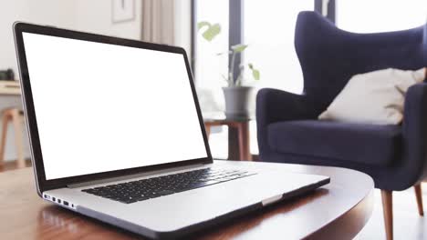 Laptop-with-copy-space-on-screen-on-coffee-table-in-sunny-living-room,-slow-motion