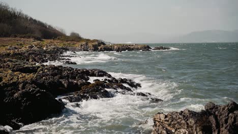 Waves-crashing-on-rocky-shore,-wide-angle,-slow-motion