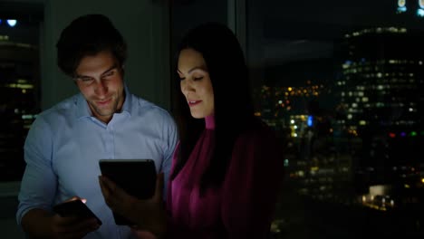 Front-view-of-young-Caucasian-office-executives-working-on-digital-tablet-in-a-modern-office-4k