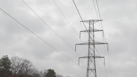 Líneas-De-Energía-Eléctrica-Que-Atraviesan-El-área-Rural-Y-El-Bosque,-Inclinación,-Suecia