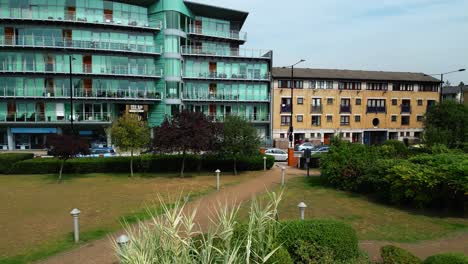 wapping high street commercial buildings seen from hermitage riverside memorial garden in london, uk