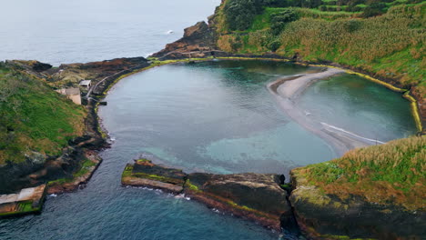 drone view island lagoon zoom out. breathtaking rocky volcanic cape in summer.