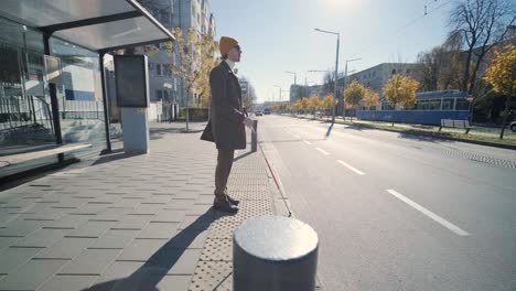 blinded man waiting for bus at a bus station