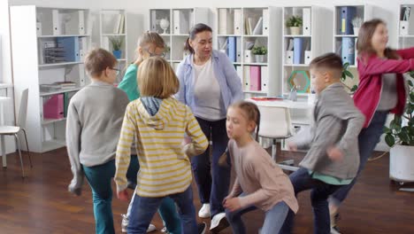 six teenage kids playing action game with teacher