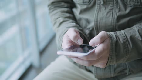 man using smartphone on metro station