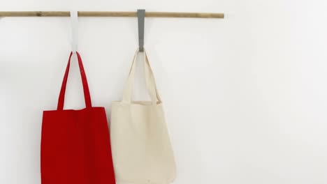 Red-and-beige-bags-hanging-on-hook-4k