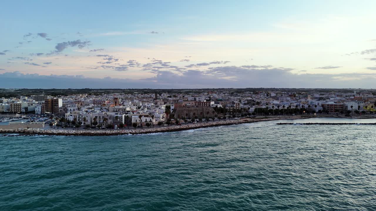 Blue sea and cozy city in Italy, aerial orbit view