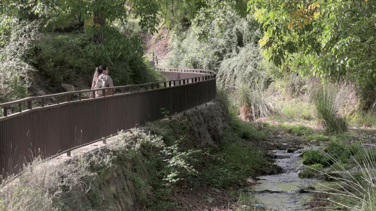 Hiker girl walking along the Taibilla River on the Zarzalar route