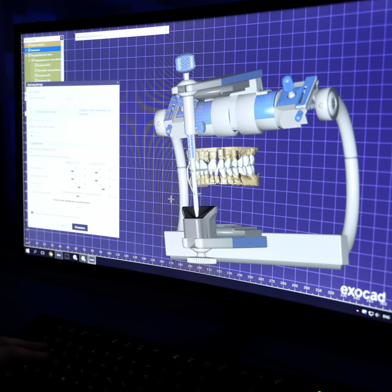 Doctor dentist on computer modeling crowns