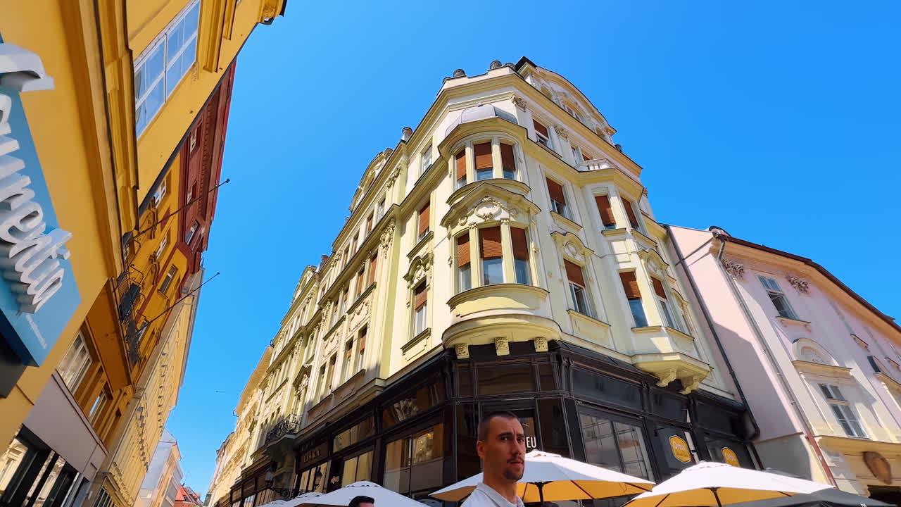 Bratislava, Slovakia, 2 June 2025: Approaching a beautiful old-fashioned four-storied buildings. A walk by the lovely street of Bratislava, Slovakia. Low angle view