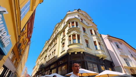 bratislava, slovakia, 2 june 2025: approaching a beautiful old-fashioned four-storied buildings. a walk by the lovely street of bratislava, slovakia. low angle view