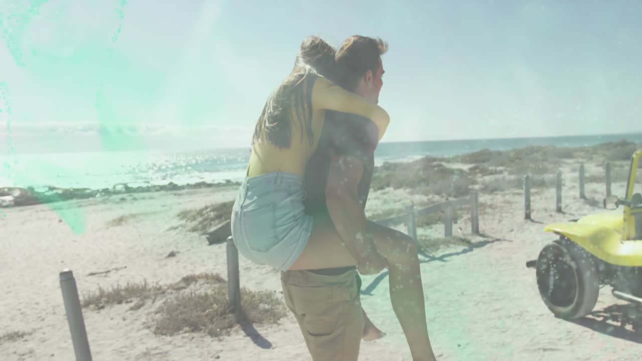 Nearing yellow buggy, man carrying woman piggyback shifting grip and helping her board for travel