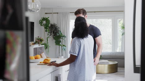 Loving-Couple-Wearing-Pyjamas-Having-Romantic-Dance-In-Kitchen-At-Home-Together