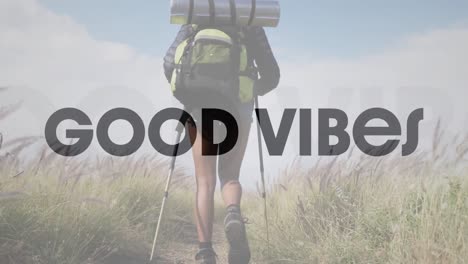 animation of the words good vibes in black over woman hiking in countryside