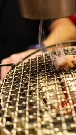 showcasing a grill's smoke suction feature