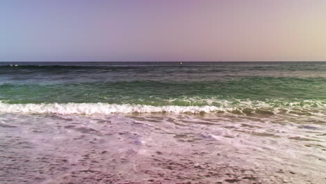 Walking-along-the-coastline-of-a-sandy-beach-at-the-Mediterranean-Sea