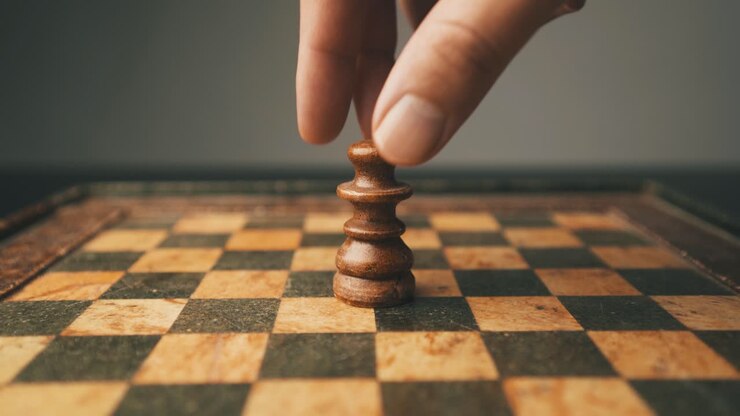 White queen chessboard male hand