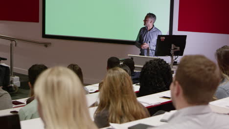 teacher in lecture theatre presenting to students, rack focus, shot on r3d