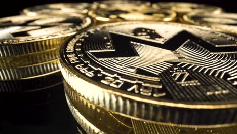 Wide-angle-macro-view-golden-monero-coins-turning-around-on-reflective-black-glass-surface,-cryptocurrency-investment-altcoin-4k