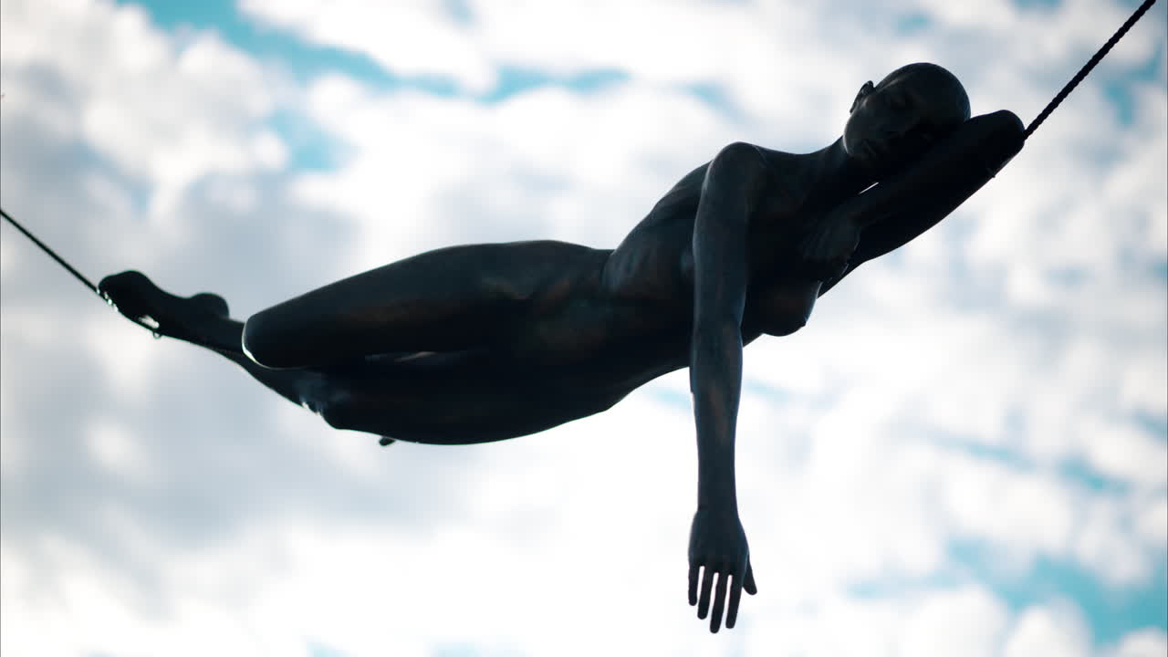 Antibes, France - October 1, 2024: Bronze Statue off a woman with the sky on the background