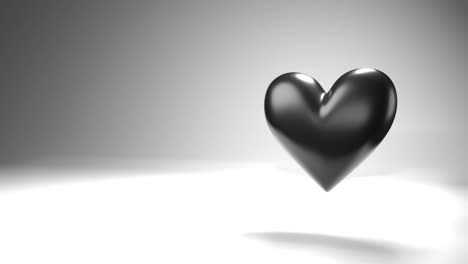 pulsing black heart shape object on white text space.