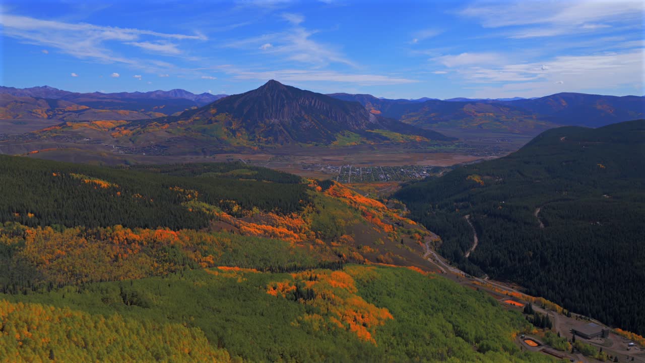 Crested Butte ski resort town drone aerial Mount Crested Butte Colorado autumn fall Gunnison national forest colorful Aspen Trees blue skies clouds Coal Creek Kebler Pass forward pan up motion