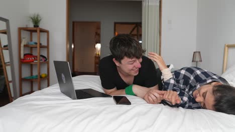 couple relaxing and playing on a bed