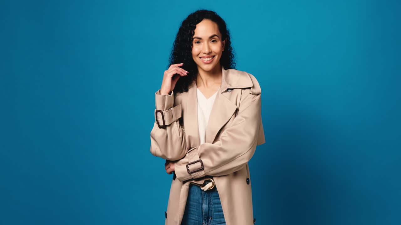 Woman in trench coat on blue background