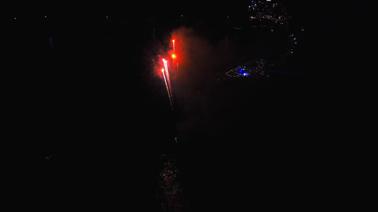 una vista aérea de drones de la explosión de fuegos artificiales por la noche en el mar