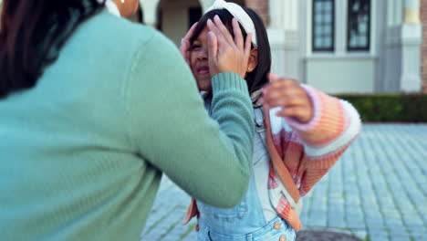 mom, kiss and goodbye to child in kindergarten