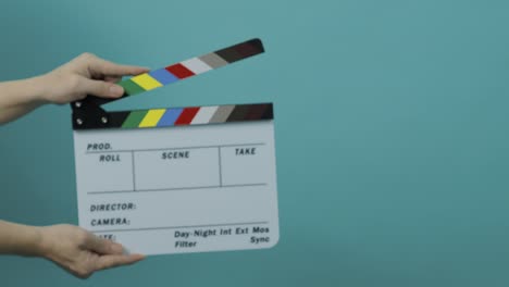 clapperboard hitting. film film slate. close up hand clapping empty film slate on blue or green screen color background. in and out film slate cutting for video production. film o film shooting.