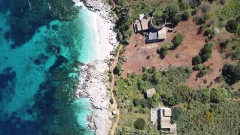 Top view of a very beautiful white sandy beach with small waves (Zingaro on the island of Sicily in Italy), sunny weather
