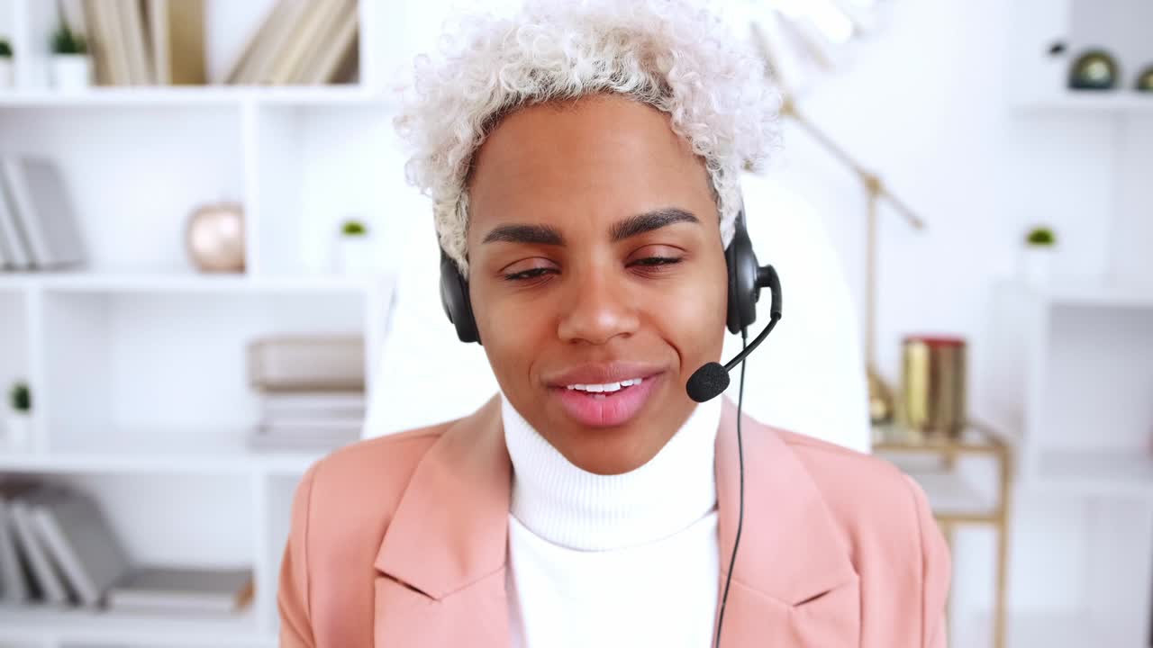 Screen view portrait african woman in headset talk on video call in office