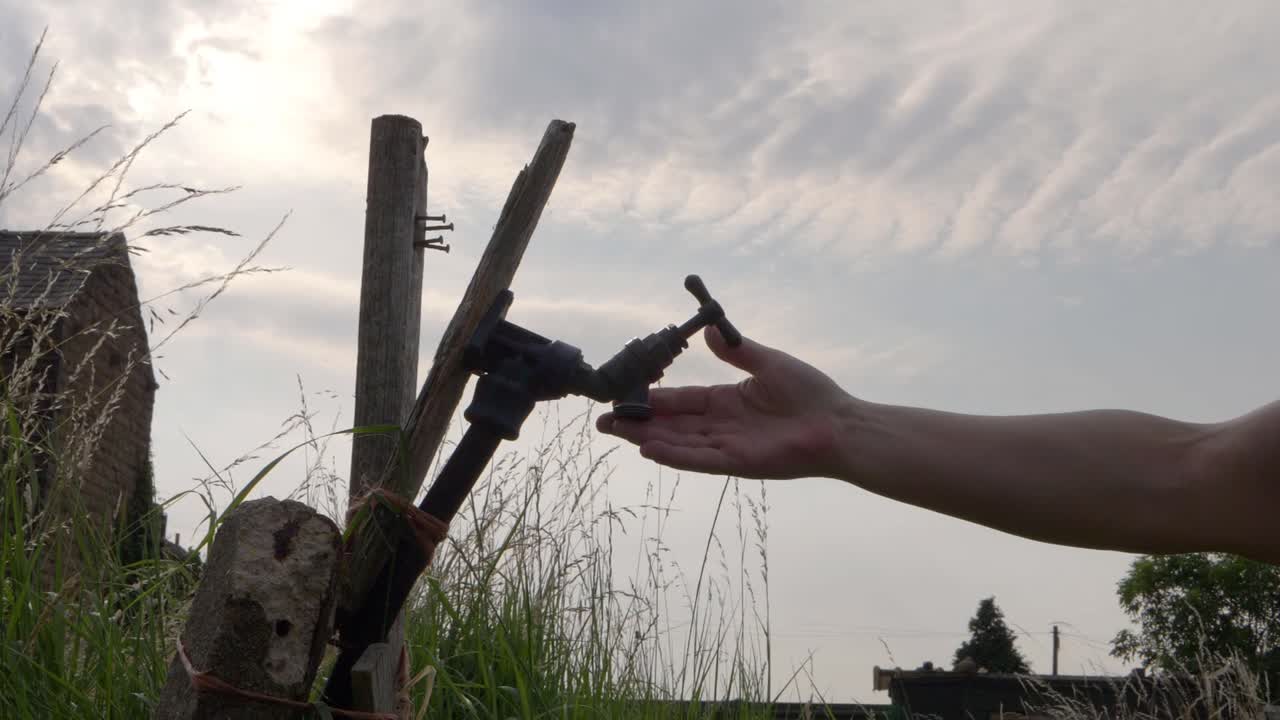 Water shortage hands trying to get water from empty faucet tap